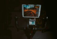 장마철 체력 유지를 위한 실내 운동 추천 person in black shorts sitting on black and red stationary bike