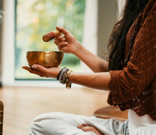 만성 피로 극복을 위한 자연 요법 woman in brown knit sweater holding brown ceramic cup