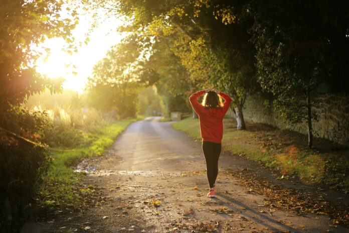 Photo by Emma Simpson woman walking on pathway during daytime
